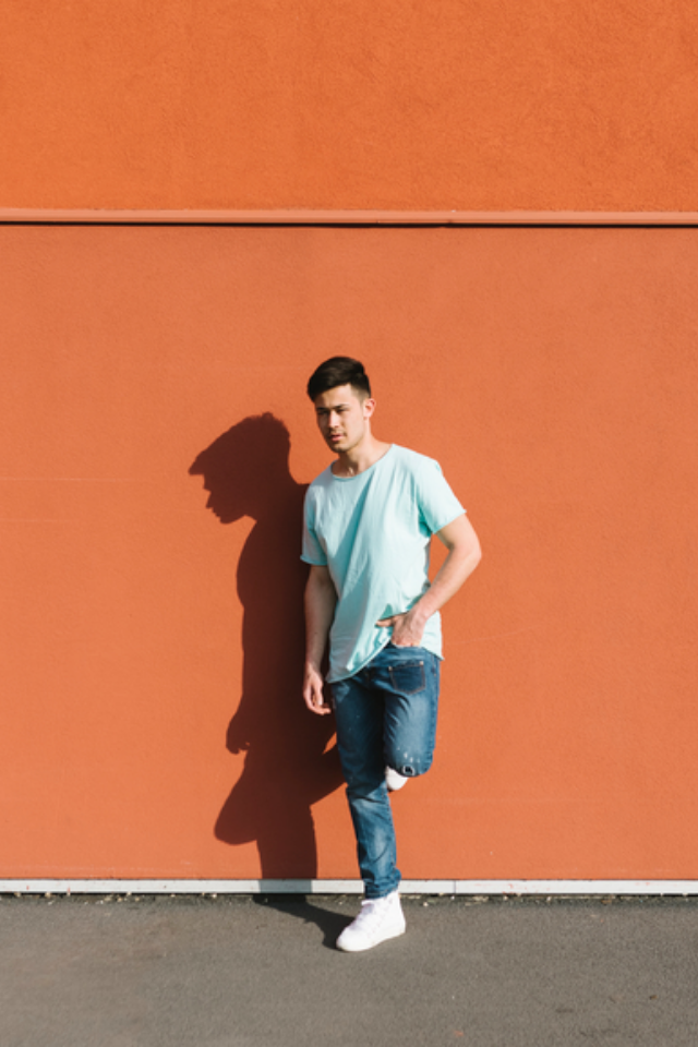 Man standing against a wall