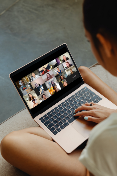 Lady with a computer on her lap on a virtual call